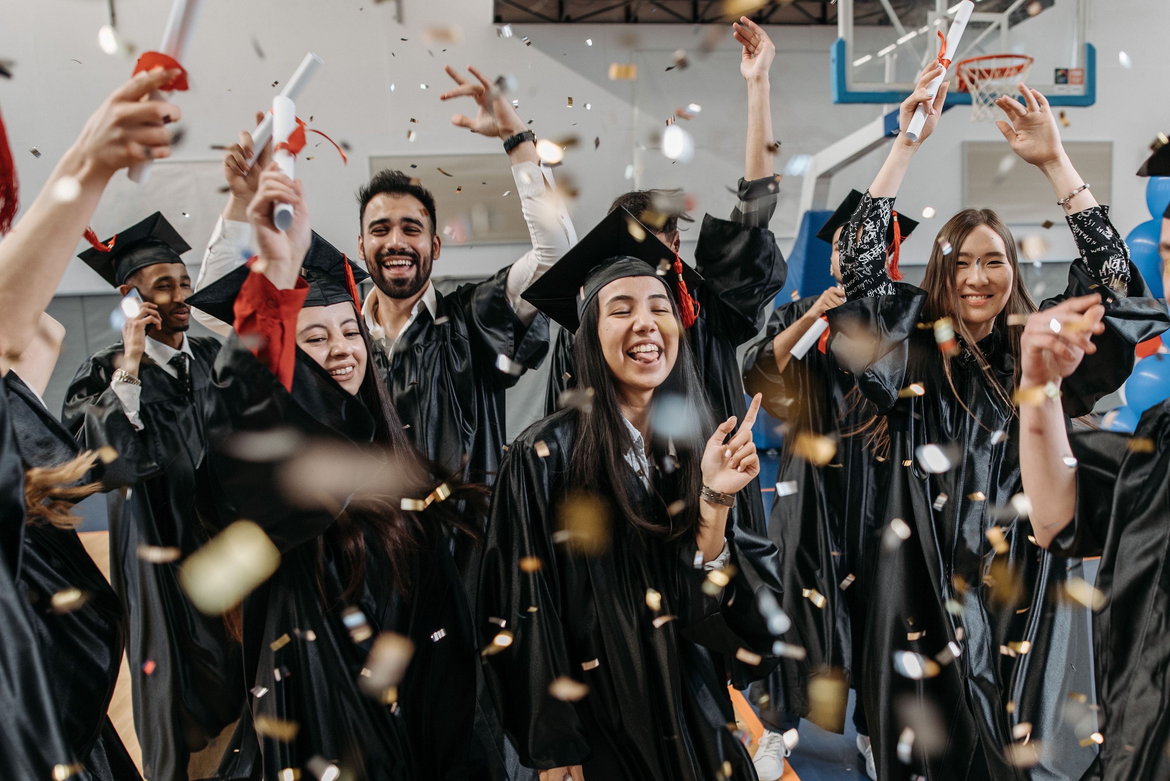 Diverse graduates in academic gowns